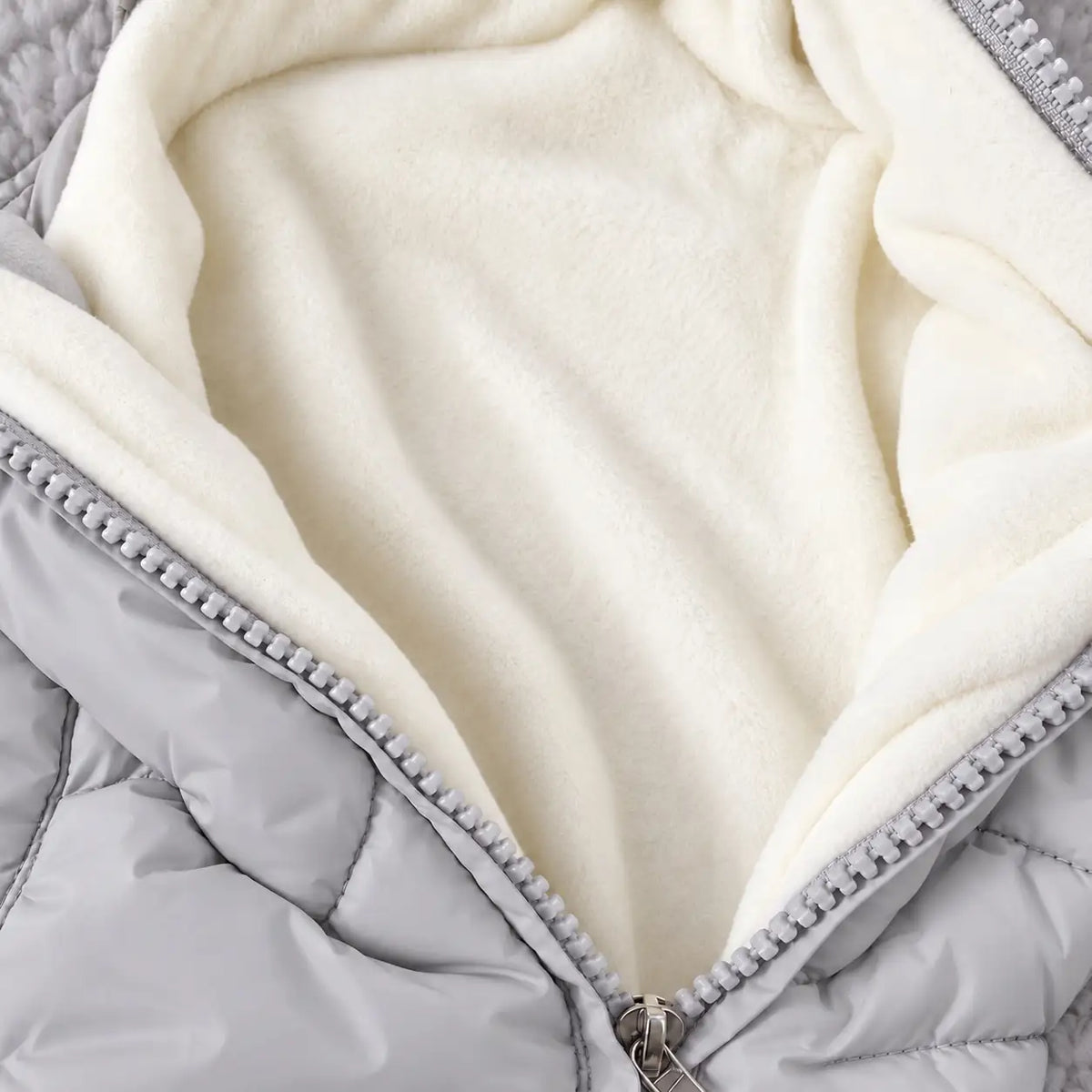 Close-up of grey baby winter puffer romper showing soft cream fleece inner lining and front zipper