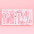 Pink baby grooming and care kit with thermometer, brush, comb, nail clipper, scissors and hygiene accessories