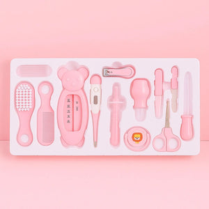 Pink baby grooming and care kit with thermometer, brush, comb, nail clipper, scissors and hygiene accessories