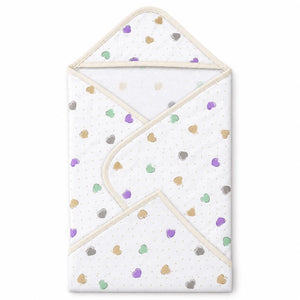Newborn baby wrapped in cream heart print hooded wrapping sheet with matching cream trim