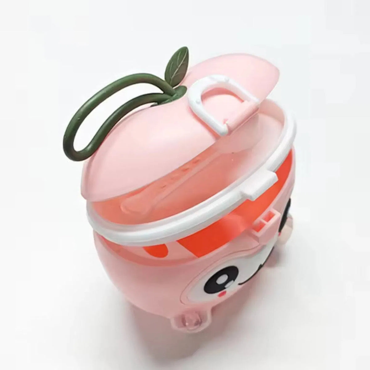 Pink apple-shape baby milk powder container shown open with scoop