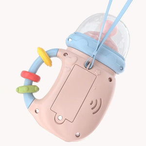 Back view of baby musical feeding bottle with battery compartment and hanging strap