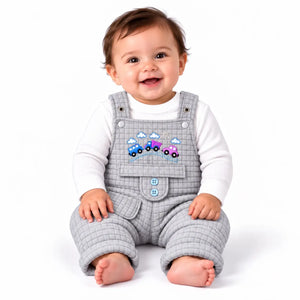 Smiling baby wearing light grey quilted dungaree romper with white inner shirt and colorful embroidered cars