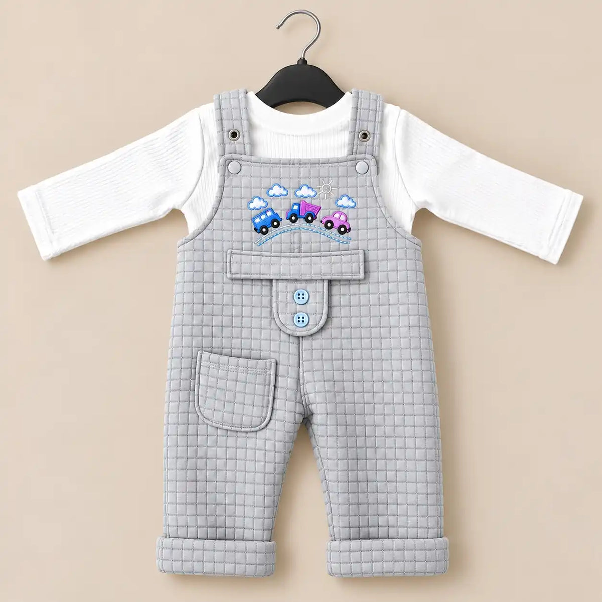 Light grey baby quilted dungaree romper with white long sleeve inner shirt, embroidered car design and front pocket