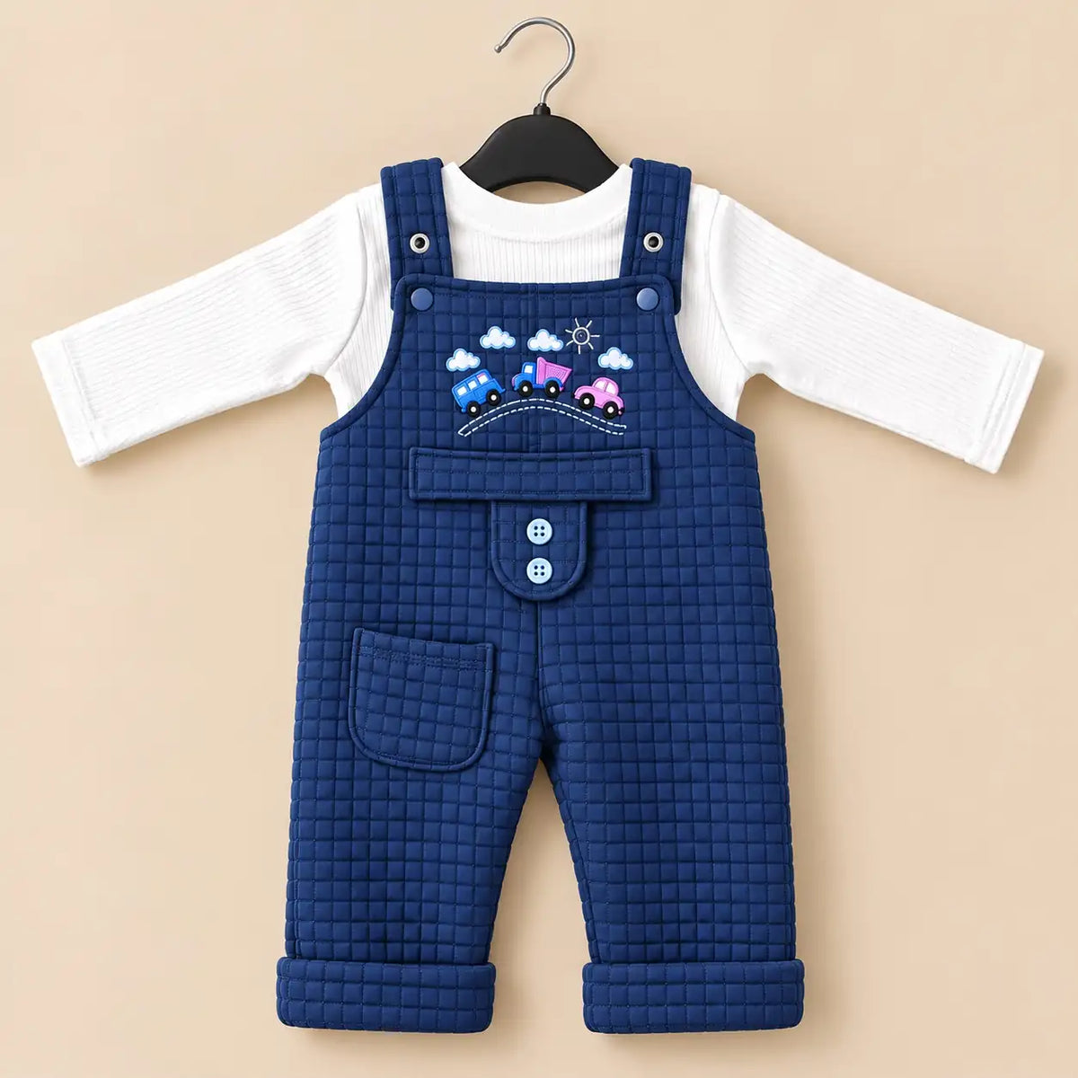 Navy blue baby quilted dungaree romper with white long sleeve inner shirt, embroidered car design and front pocket