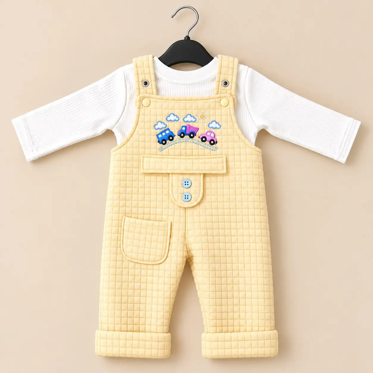 Light yellow baby quilted dungaree romper with white long sleeve inner shirt, embroidered car design and front pocket