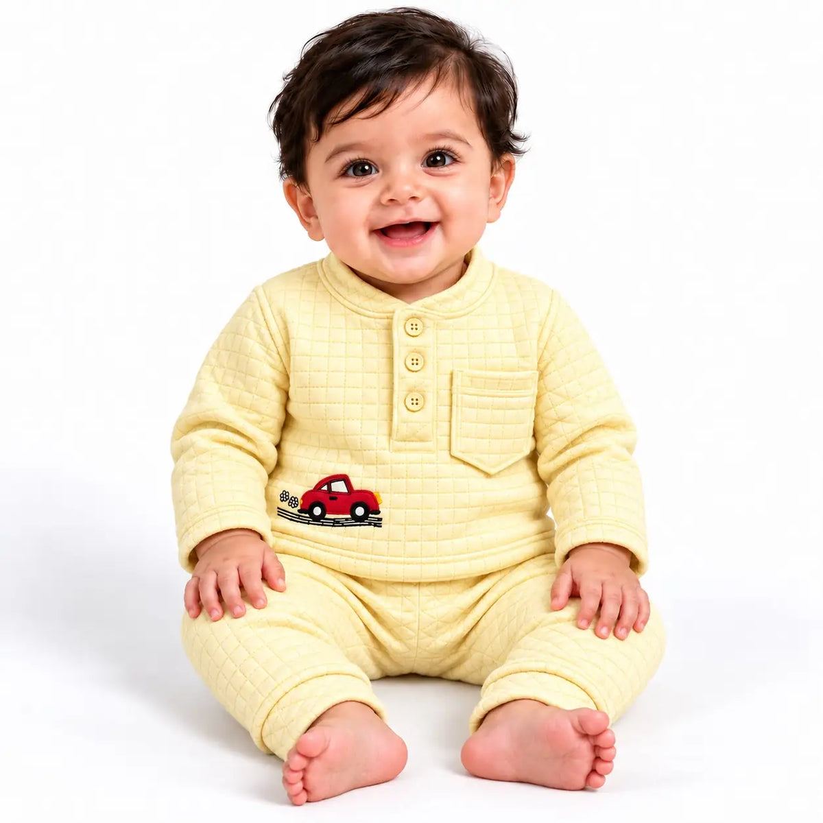 Baby wearing a yellow textured jacquard knit winter shirt and pajama set with red car embroidery