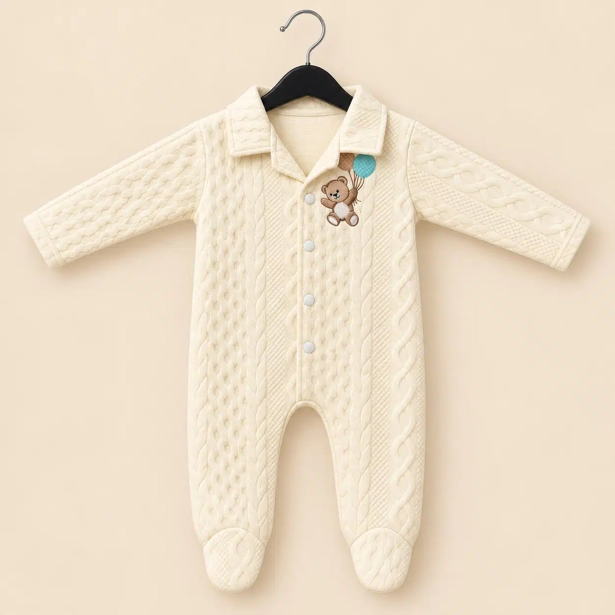 Baby winter quilted footed romper in cream with teddy bear embroidery, front snap buttons and long sleeves