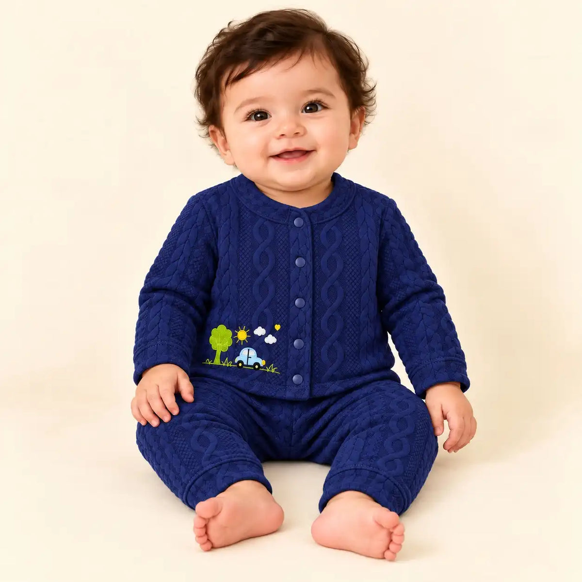 Baby wearing navy blue textured jacquard knit shirt and pajama set with car, tree and sunshine embroidery