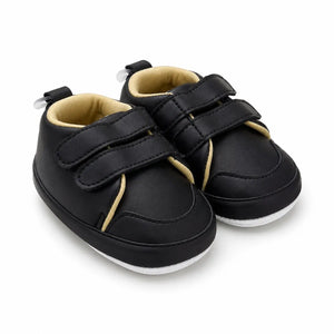 Side-angle view of black baby prewalker shoes with cream contrast lining