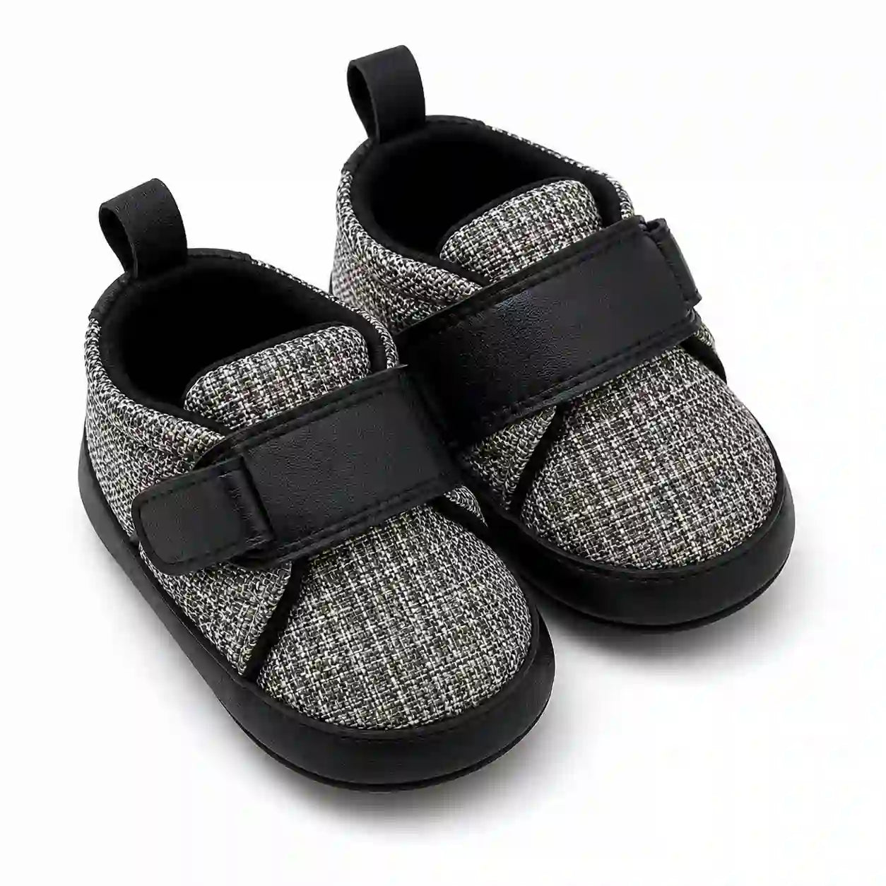 Black and grey textured baby shoes with adjustable strap angled view