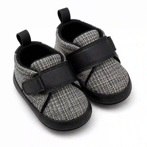 Black and grey textured baby shoes with adjustable strap angled view