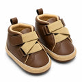 Brown cross strap casual baby shoes with beige detailing angled view