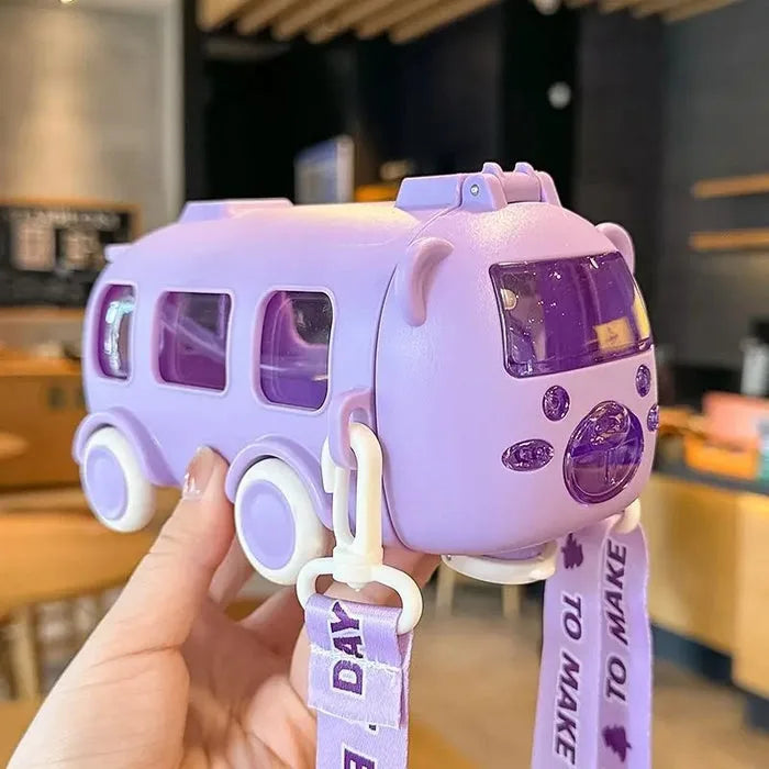 Purple bus-shaped kids water bottle shown in hand with straw lid