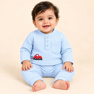Baby wearing a sky blue textured winter shirt and pajama set with red car embroidery