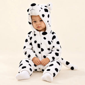 Child sitting in black and white Puppy Fleece Costume Jumpsuit with 3D puppy hood, front zipper and spotted plush tail