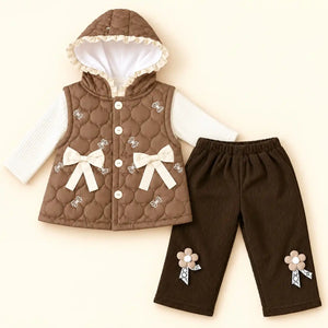 Brown quilted hooded vest with cream bow and floral details layered over ribbed top, paired with dark brown girls winter pajama