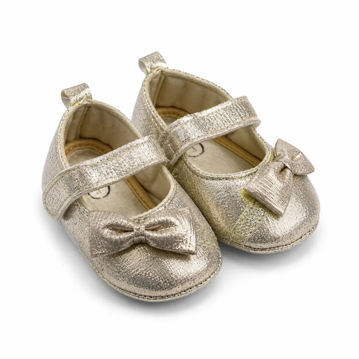 Side-angle view of gold baby girl shoes with bow and hook-and-loop strap