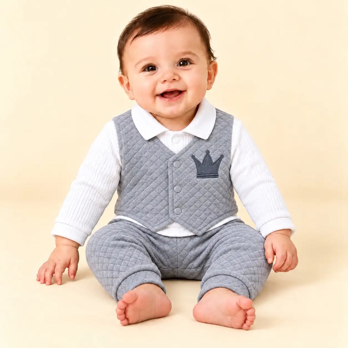 Baby wearing grey quilted attached waistcoat shirt with crown embroidery and matching grey pajama