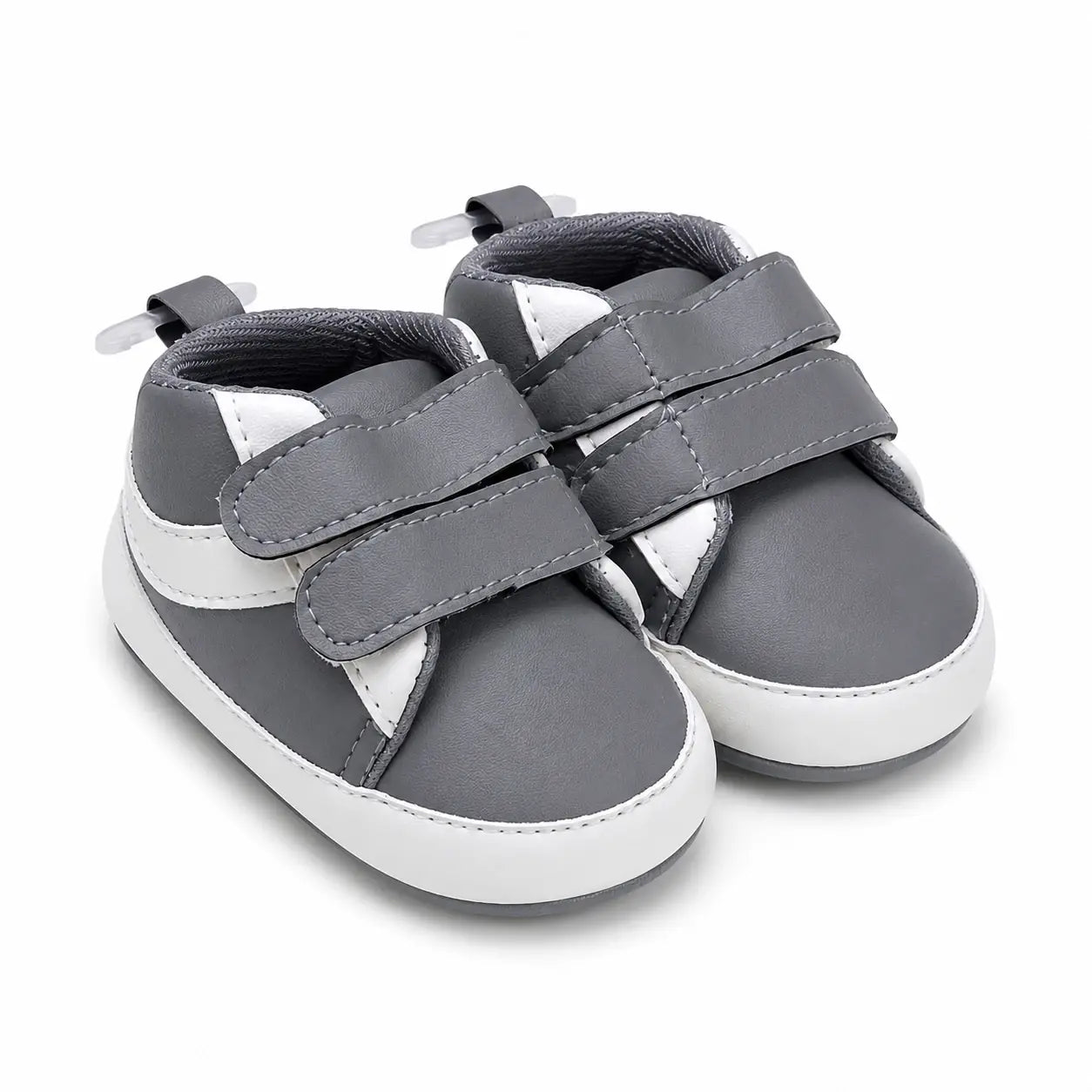 Side-angle view of baby boys grey and white soft sole double strap shoes