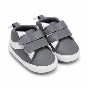 Side-angle view of baby boys grey and white soft sole double strap shoes