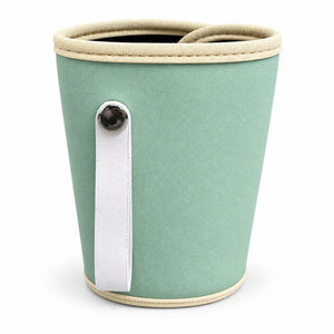 Green baby bottle warmer back showing carrying strap, textured exterior and cream edging