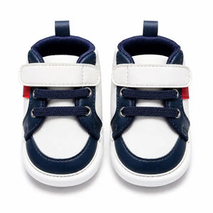 White and navy blue strap baby shoes with lace detailing front view