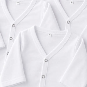 Newborn baby white front open shirt snap button and fabric close-up
