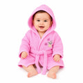 Baby wearing pink hooded bathrobe with bunny embroidery