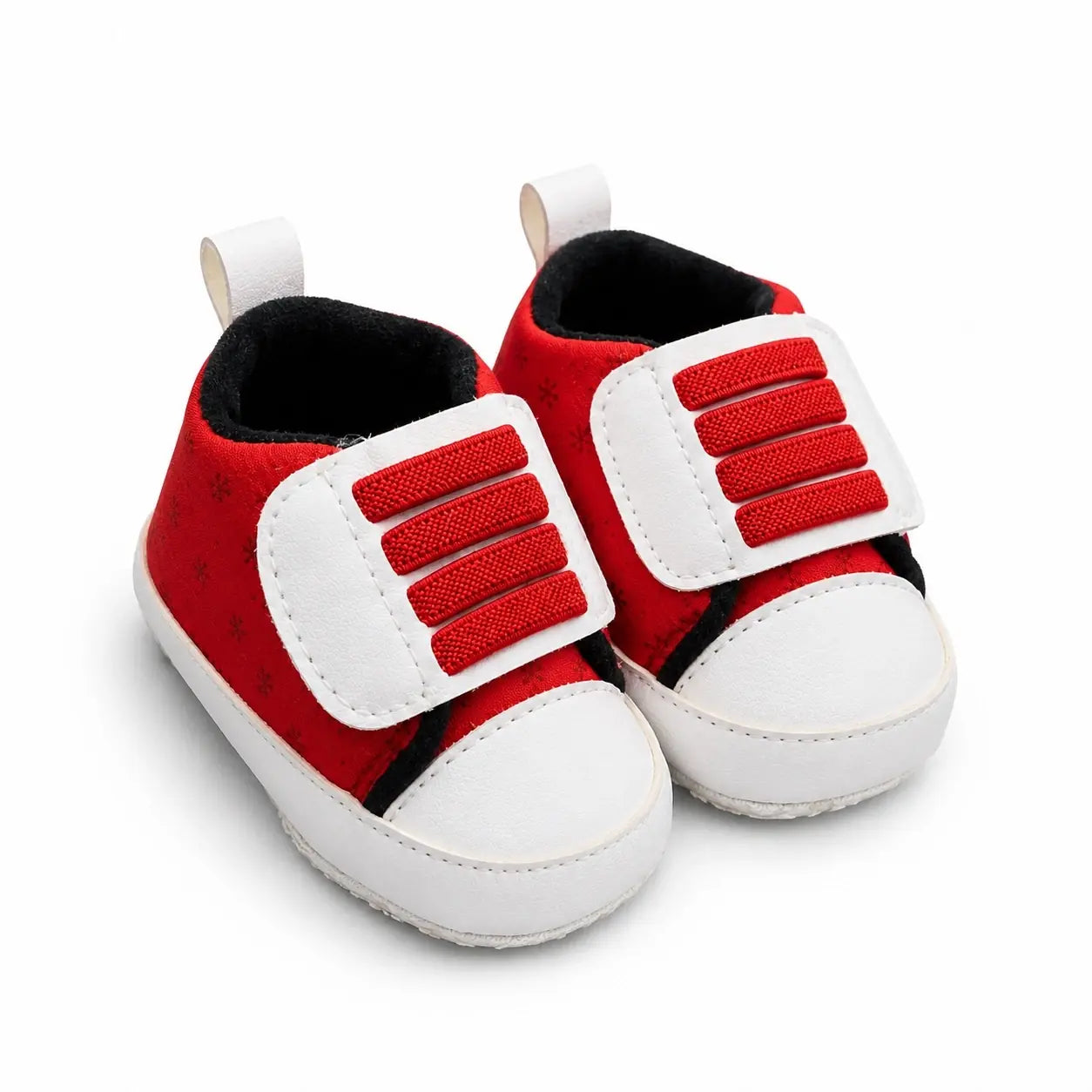 Side-angle view of red and white Velcro prewalker shoes for babies