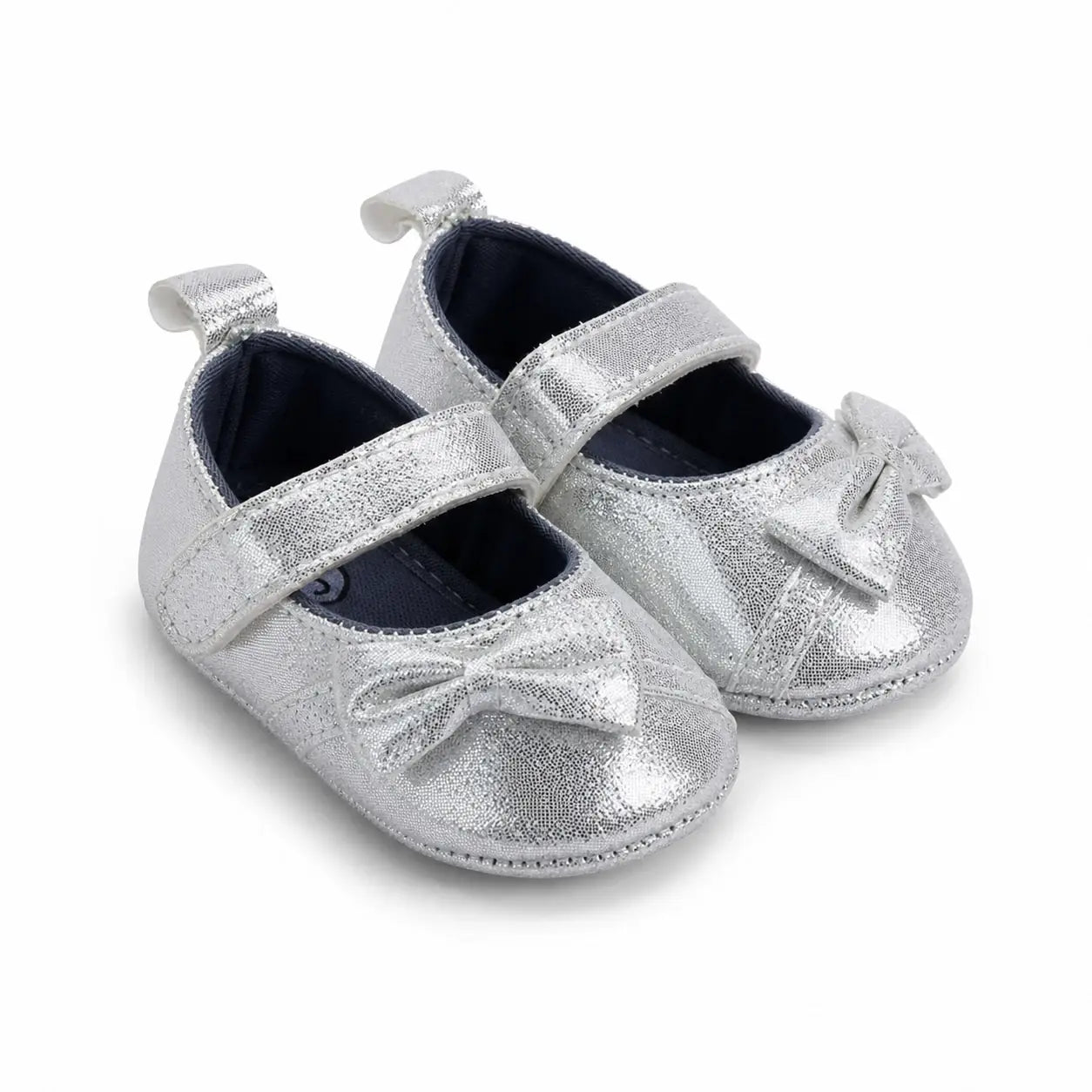 Side-angle view of silver baby girl shoes with bow and adjustable strap