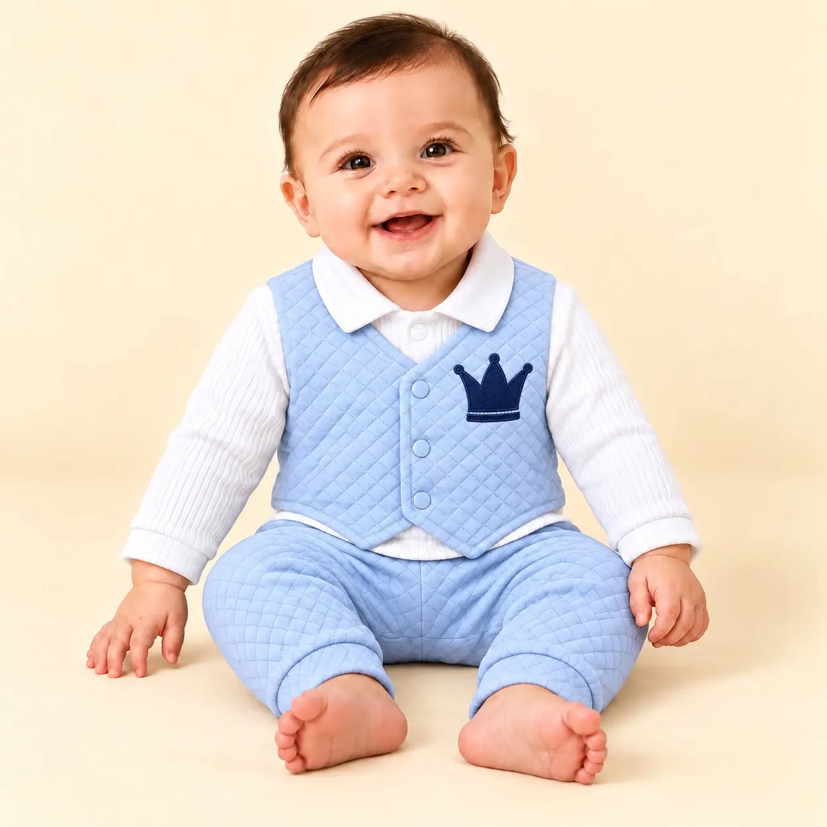 Baby wearing sky blue quilted attached waistcoat shirt with navy blue crown embroidery and matching sky blue pajama