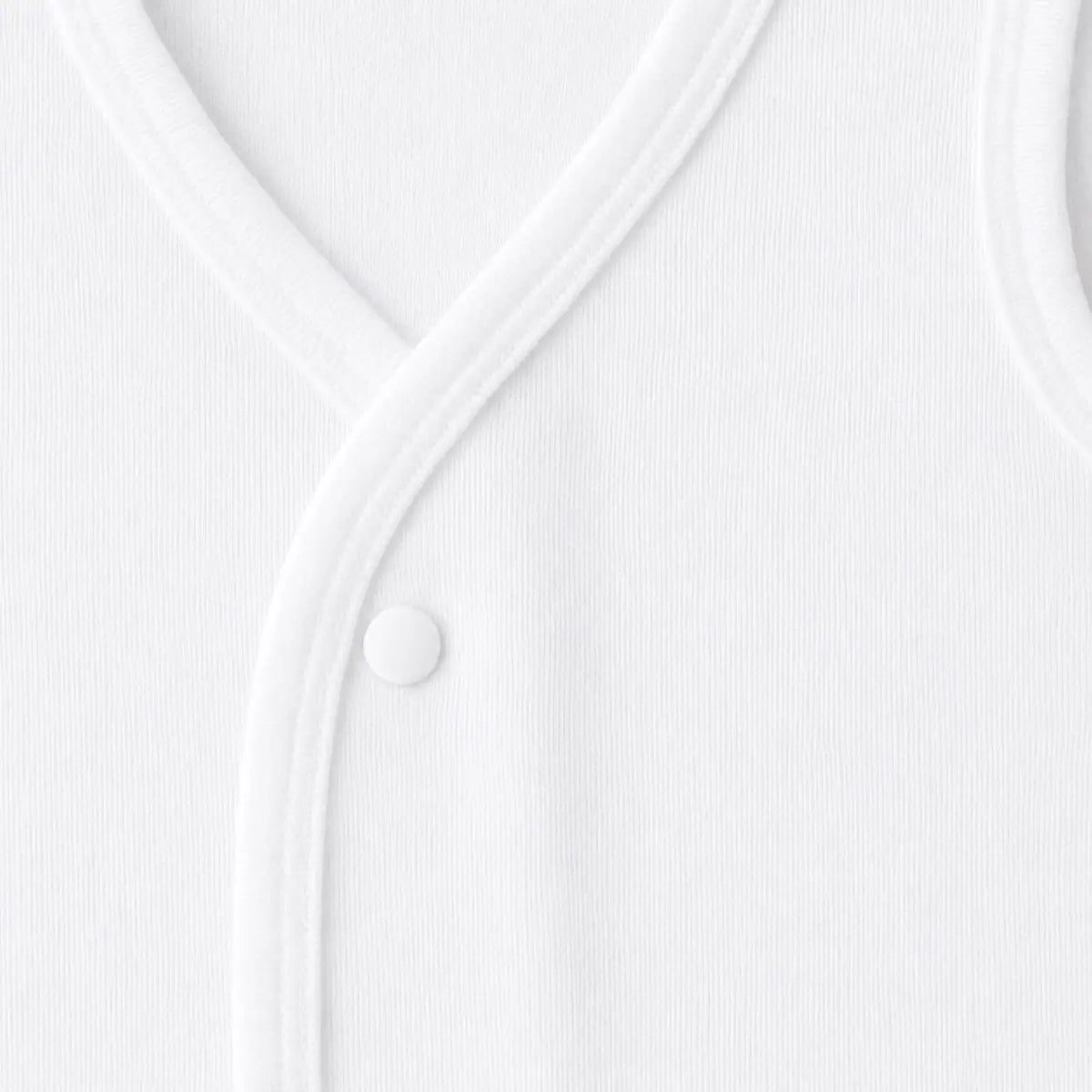 Close-up of soft white baby inner vest fabric and stitching