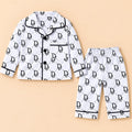 Black-and-white monogram print baby night suit with a collared button-front shirt and matching elastic-waist pajamas