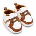 White and brown casual baby shoes with strap closure angled view