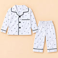 White printed baby night suit with small bird and leaf motifs, a collared button-front shirt and matching pajamas
