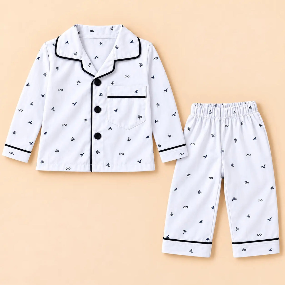 White printed baby night suit with small bird and leaf motifs, a collared button-front shirt and matching pajamas