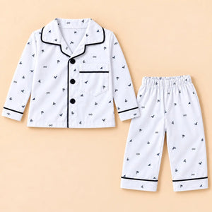 White printed baby night suit with small bird and leaf motifs, a collared button-front shirt and matching pajamas