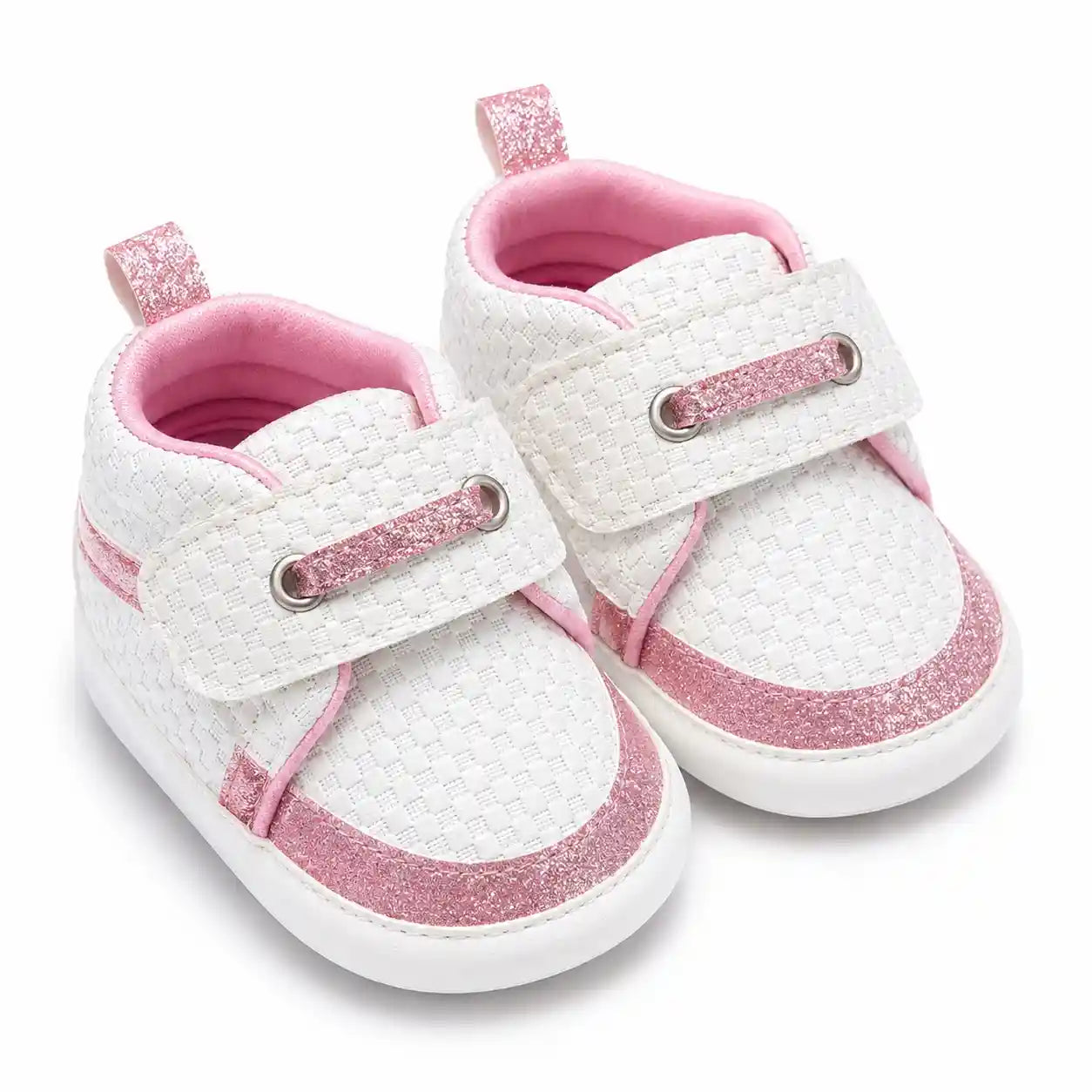 White textured baby shoes with pink glitter accents and strap closure angled view