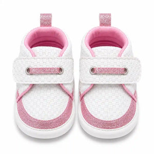 White and pink glitter baby shoes with textured upper and strap closure front view